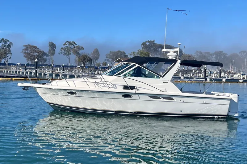 The Image of 2002 Tiara Yachts 2900 Open cruising in a marina under clear blue skies. - 0