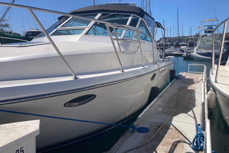 Slide: The Image of 2002 Tiara Yachts 2900 Open docked at marina, sunny day, clear blue sky. - 10