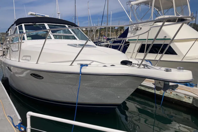 Slide: The Image of 2002 Tiara Yachts 2900 Open docked at marina, featuring sleek design and sturdy build. - 11