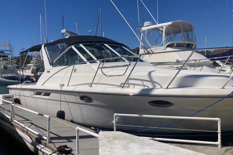 Slide: The Image of 2002 Tiara Yachts 2900 Open docked at marina under clear blue sky. - 12