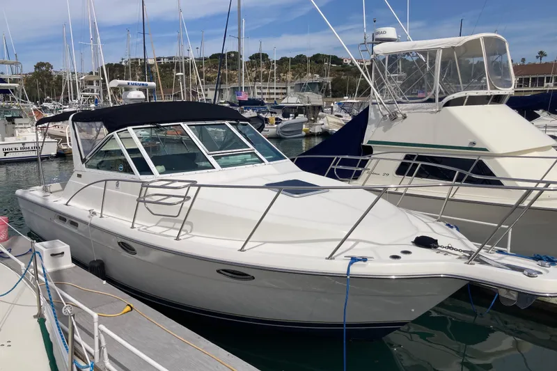 Slide: The Image of 2002 Tiara Yachts 2900 Open docked in a marina, surrounded by other boats. - 13