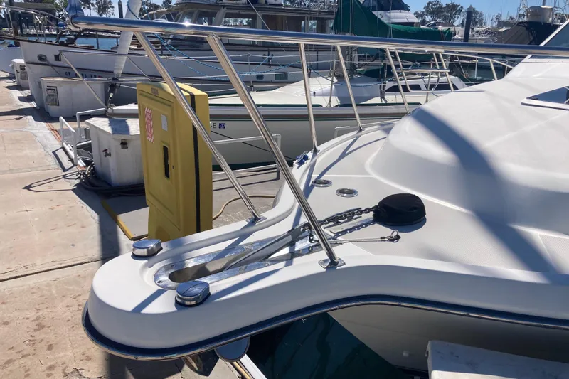 Slide: The Image of 2002 Tiara Yachts 2900 Open docked, showcasing bow and railing details. - 18