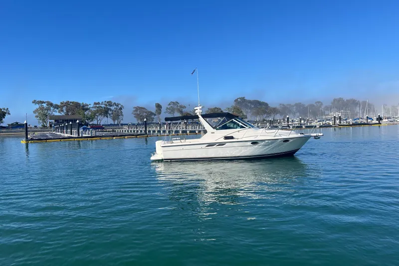 Slide: The Image of 2002 Tiara Yachts 2900 Open cruising in a serene marina setting. - 2