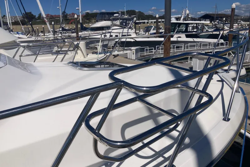 Slide: The Image of 2002 Tiara Yachts 2900 Open at marina, showcasing sleek stainless steel railings. - 21
