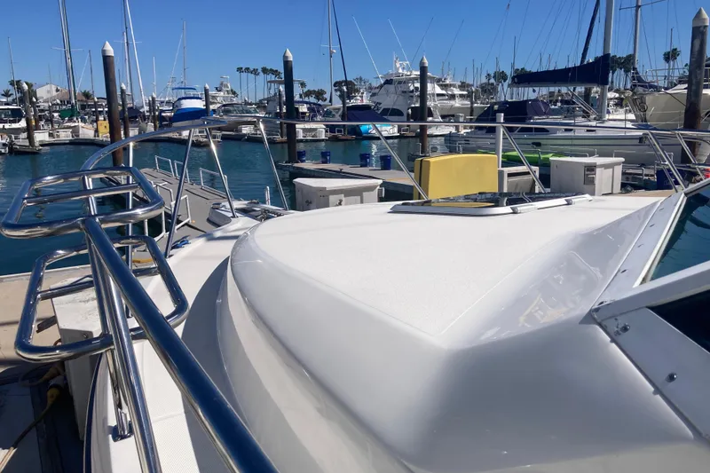 Slide: The Image of 2002 Tiara Yachts 2900 Open docked in a marina, surrounded by other boats. - 24