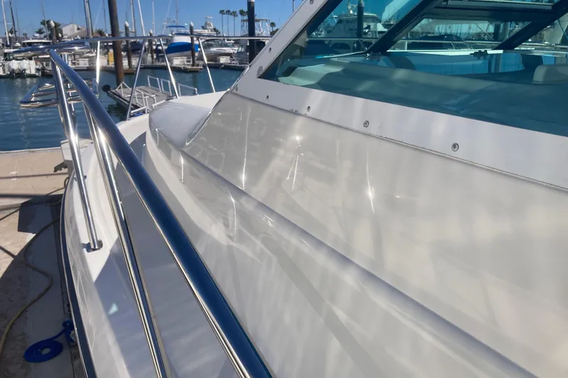 Slide: The Image of 2002 Tiara Yachts 2900 Open docked at marina, showcasing sleek design and polished exterior. - 26