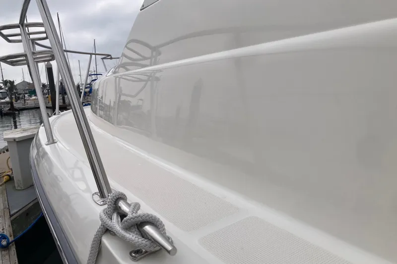 Slide: The Image of 2002 Tiara Yachts 2900 Open, sleek white exterior, docked at marina. - 27