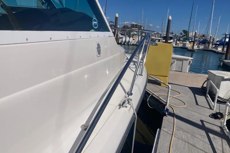 Slide: The Image of 2002 Tiara Yachts 2900 Open docked at marina under clear blue sky. - 28