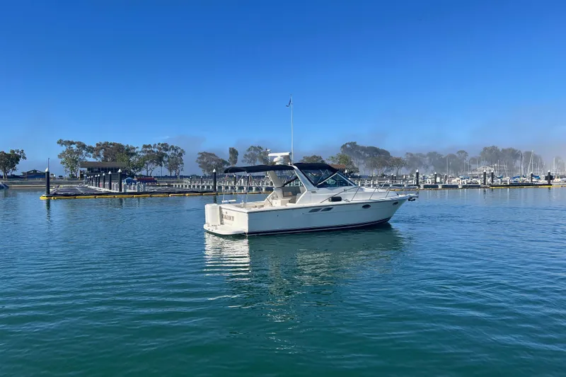 Slide: The Image of 2002 Tiara Yachts 2900 Open cruising in a marina under clear blue skies. - 3
