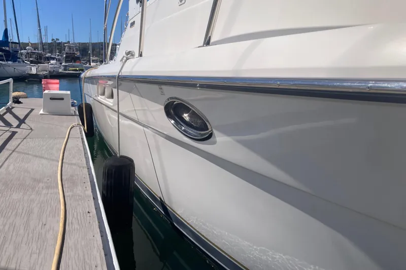 Slide: The Image of 2002 Tiara Yachts 2900 Open docked at marina, side view with clear sky. - 31