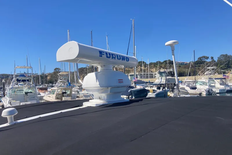 Slide: The Image of 2002 Tiara Yachts 2900 Open with radar, docked in a marina under clear blue skies. - 33