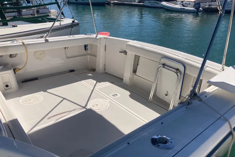 Slide: The Image of 2002 Tiara Yachts 2900 Open boat deck at marina, featuring spacious seating area. - 36