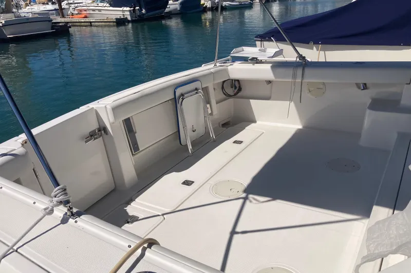 Slide: The Image of 2002 Tiara Yachts 2900 Open boat deck, docked in a marina. - 38