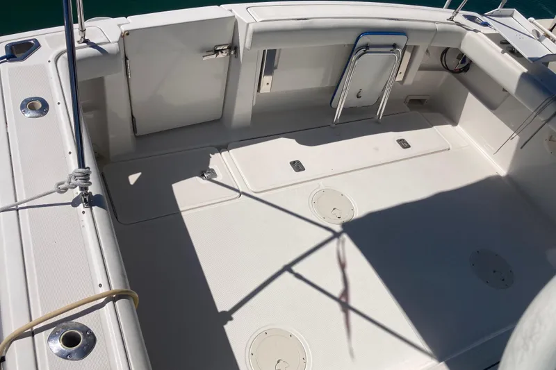 Slide: The Image of 2002 Tiara Yachts 2900 Open boat deck, featuring spacious seating and storage areas. - 39