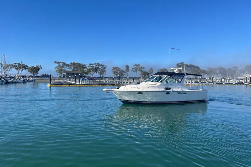 Slide: The Image of 2002 Tiara Yachts 2900 Open cruising in a serene marina setting. - 4