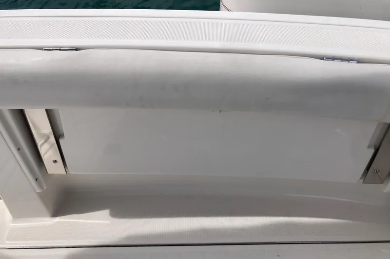 Slide: The Image of 2002 Tiara Yachts 2900 Open boat interior detail, featuring white cushioned seating. - 40