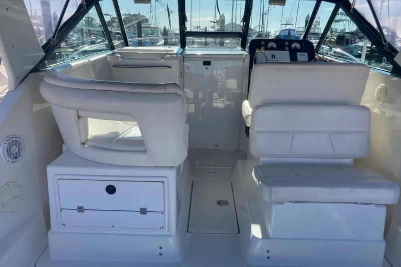 Slide: The Image of Interior of a 2002 Tiara Yachts 2900 Open, featuring white seating and helm. - 44