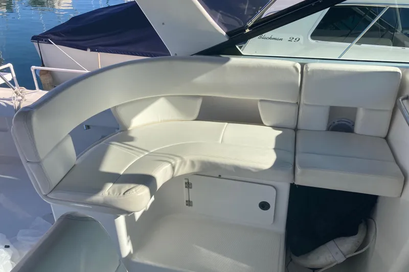 Slide: The Image of 2002 Tiara Yachts 2900 Open with white cushioned seating in the cockpit area. - 46