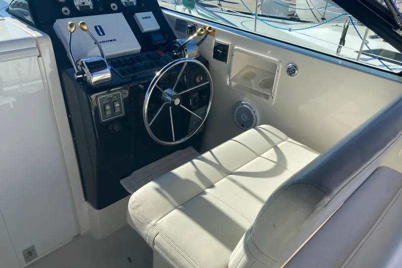 Slide: The Image of Helm of 2002 Tiara Yachts 2900 Open with steering wheel and controls. - 48