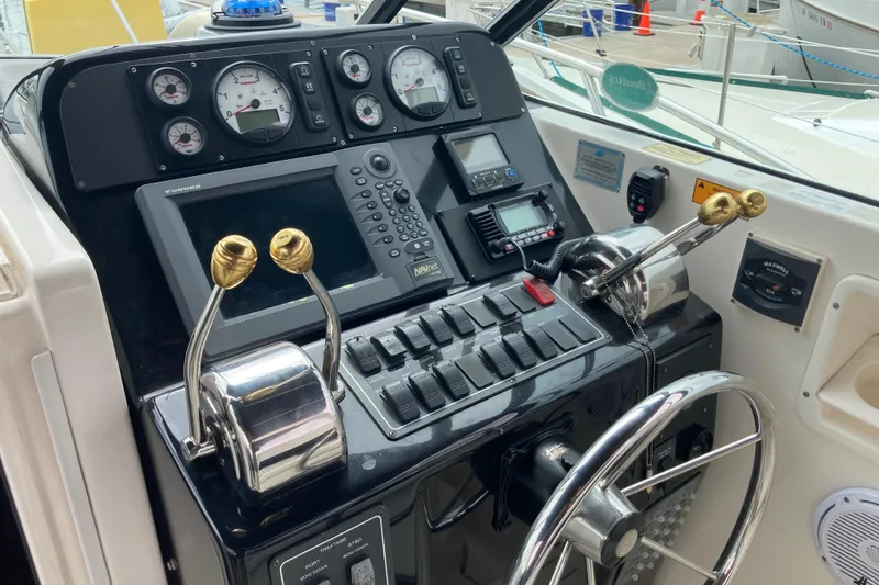 Slide: The Image of Control panel of a 2002 Tiara Yachts 2900 Open, featuring gauges and navigation equipment. - 49