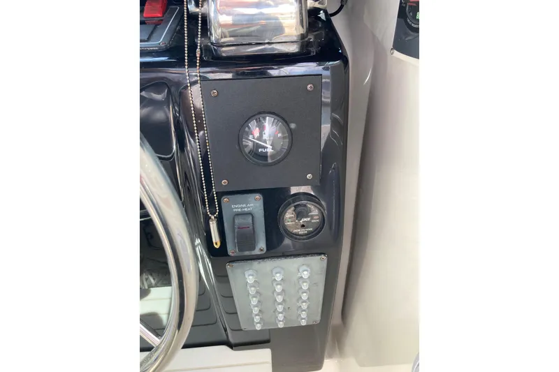 Slide: The Image of Dashboard of a 2002 Tiara Yachts 2900 Open, featuring gauges and controls. - 53