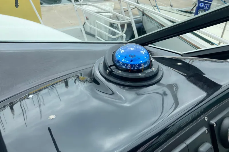Slide: The Image of Compass on 2002 Tiara Yachts 2900 Open dashboard, docked at marina. - 54