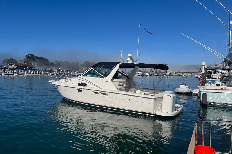 Slide: The Image of 2002 Tiara Yachts 2900 Open docked in a marina under clear blue skies. - 6