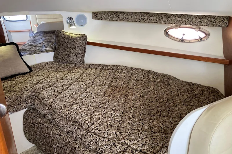 Slide: The Image of Cozy cabin interior of 2002 Tiara Yachts 2900 Open with patterned bedding. - 63