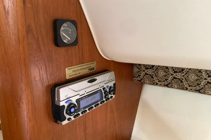 Slide: The Image of 2002 Tiara Yachts 2900 Open interior with radio and fuel gauge on wooden panel. - 65