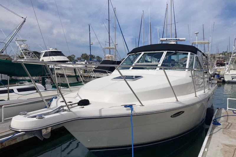 Slide: The Image of 2002 Tiara Yachts 2900 Open docked at marina, surrounded by sailboats. - 7