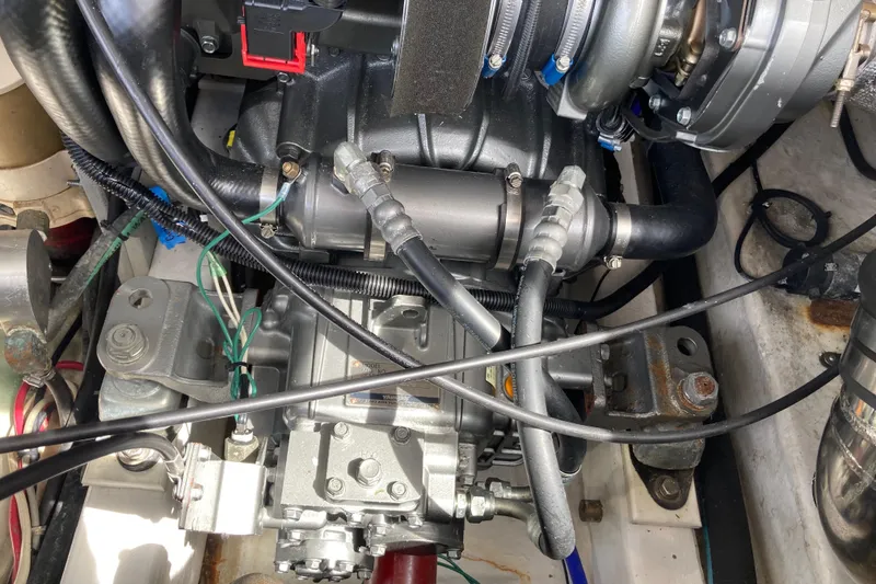 Slide: The Image of Engine compartment of a 2002 Tiara Yachts 2900 Open, showcasing mechanical components and wiring. - 76
