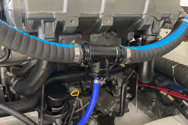 Slide: The Image of Engine compartment of a 2002 Tiara Yachts 2900 Open, featuring hoses and mechanical components. - 79