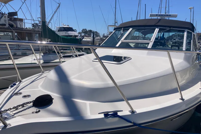 Slide: The Image of 2002 Tiara Yachts 2900 Open docked, showcasing sleek design and sturdy railings. - 9