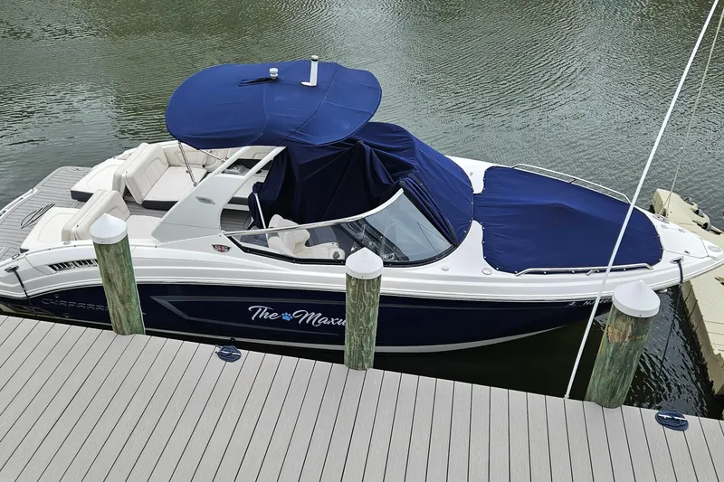 The Image of 2018 Chaparral 257 SSX boat docked with blue covers and canopy. - 0