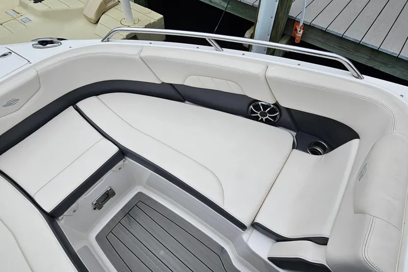 Slide: The Image of 2018 Chaparral 257 SSX boat interior with white seating and speaker detail. - 10