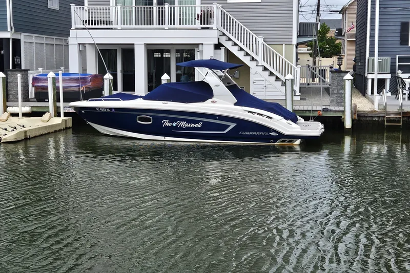Slide: The Image of 2018 Chaparral 257 SSX boat docked by waterfront home. - 19