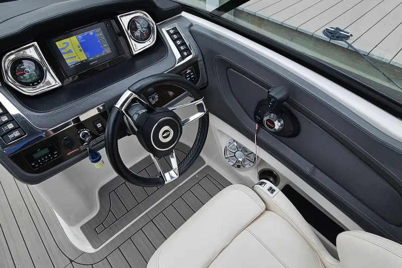 Slide: The Image of 2018 Chaparral 257 SSX boat dashboard with steering wheel and navigation display. - 3