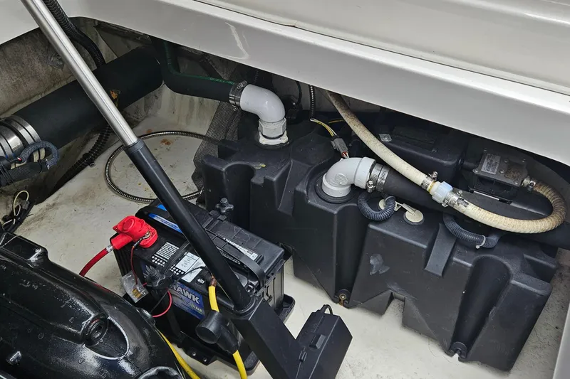 Slide: The Image of Engine compartment of 2018 Chaparral 257 SSX boat showing battery and hoses. - 7