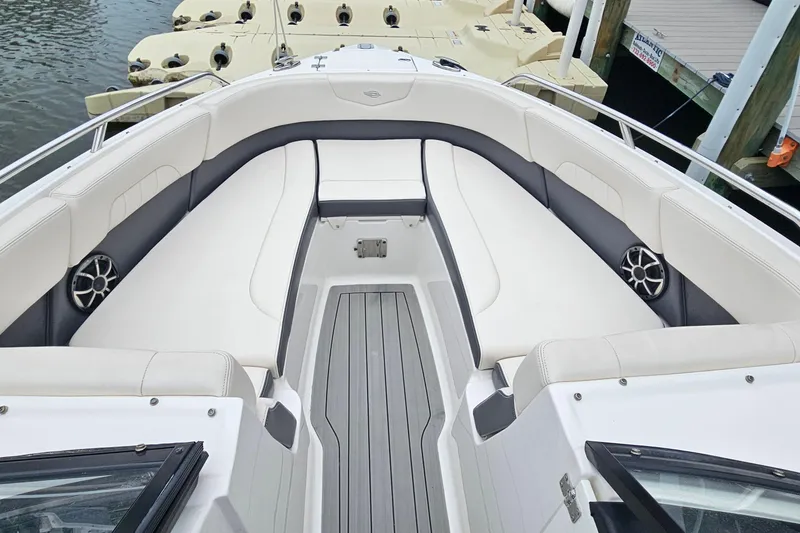 Slide: The Image of 2018 Chaparral 257 SSX boat interior with white seating and gray flooring. - 8