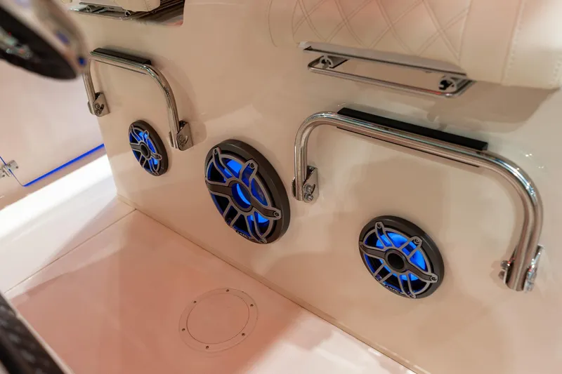 Slide: The Image of 2026 Grady-White Canyon 306 boat interior with blue LED speakers and chrome handles. - 11