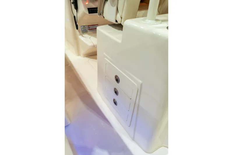 Slide: The Image of 2026 Grady-White Canyon 306 boat interior with storage compartments and control panel. - 12