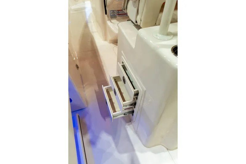 Slide: The Image of Open storage drawers on a 2026 Grady-White Canyon 306 boat interior. - 13