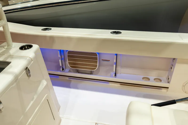 Slide: The Image of 2026 Grady-White Canyon 306 boat interior with storage compartment and cup holders. - 14