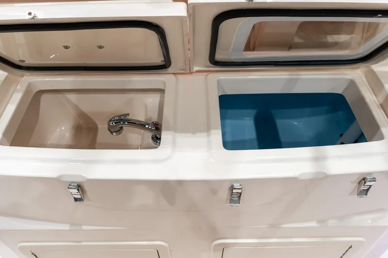 Slide: The Image of Grady-White Canyon 306 (2026) boat sink and storage compartments, featuring sleek design and functionality. - 17