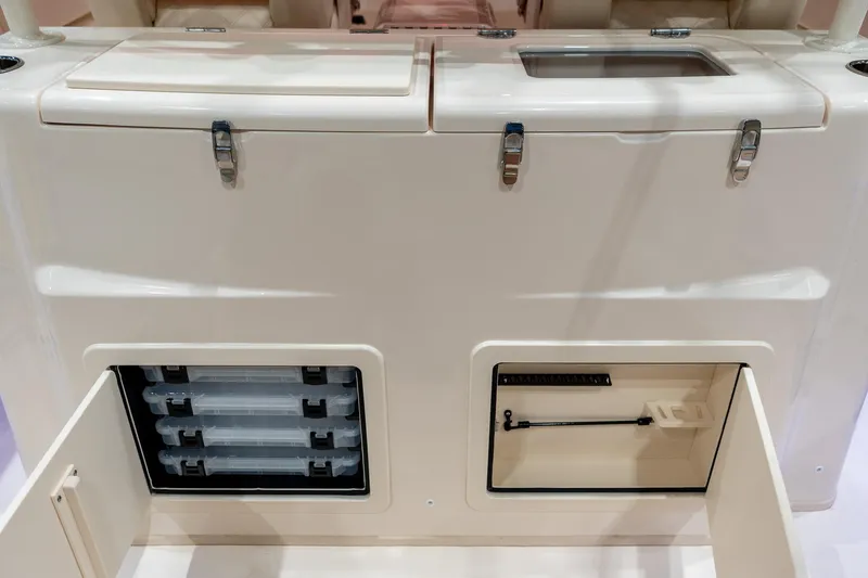 Slide: The Image of 2026 Grady-White Canyon 306 boat storage compartments and tackle boxes. - 18
