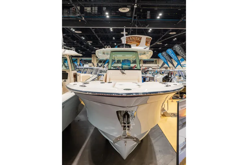 Slide: The Image of 2026 Grady-White Canyon 306 boat displayed at a marine exhibition. - 2