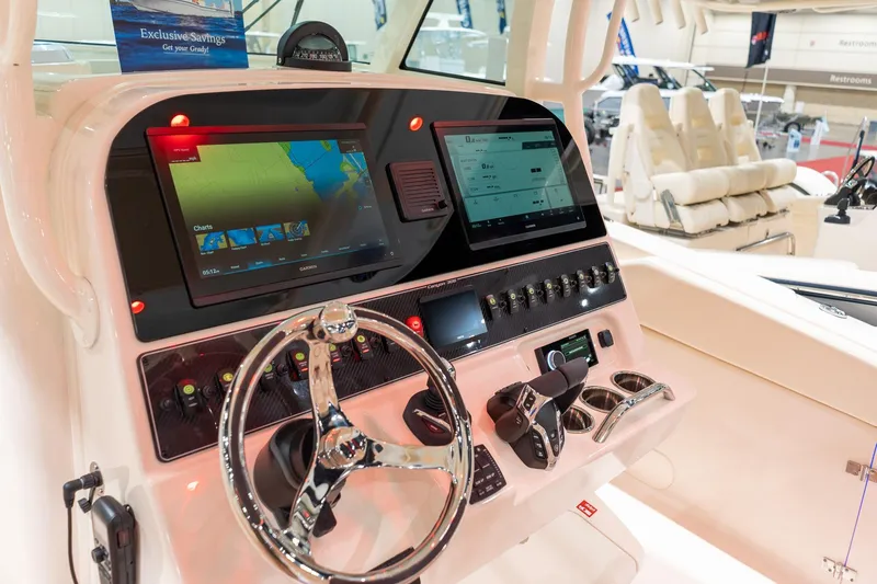 Slide: The Image of 2026 Grady-White Canyon 306 boat dashboard with advanced navigation displays and controls. - 4