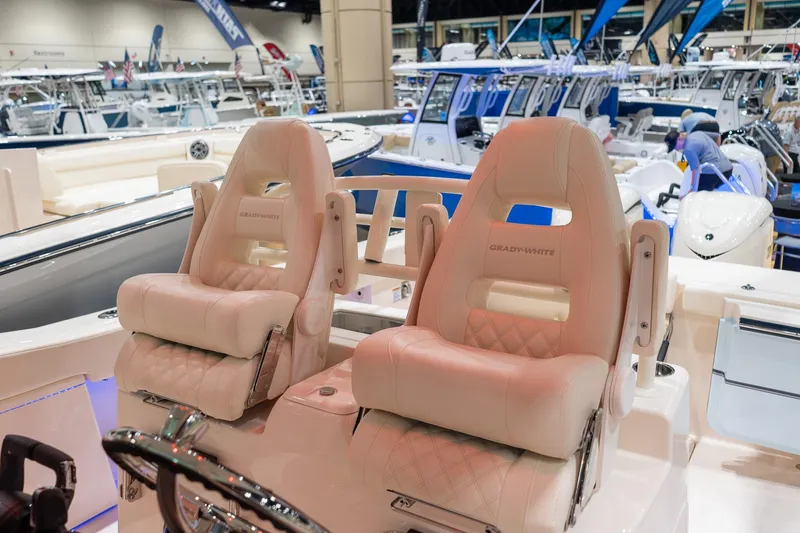 Slide: The Image of Luxury seating on 2026 Grady-White Canyon 306 boat at a marine exhibition. - 8