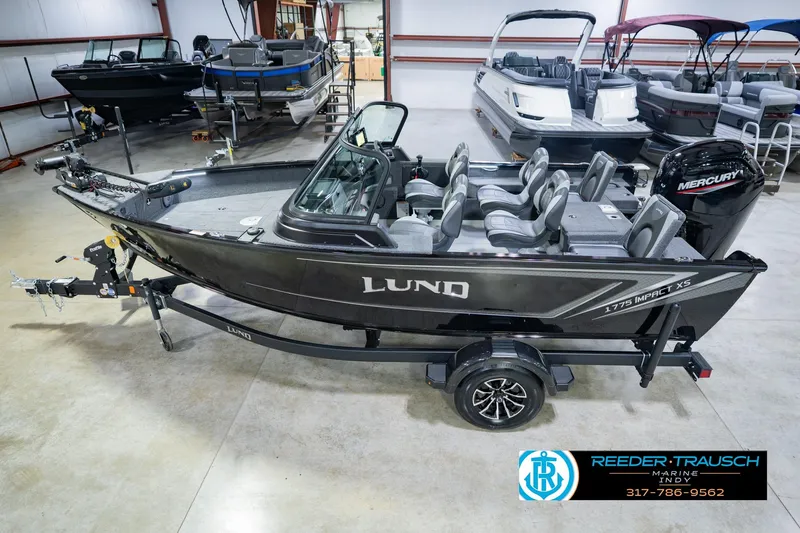 The Image of 2026 Lund 1775 Impact XS boat in showroom with Mercury engine, trailer included. - 0