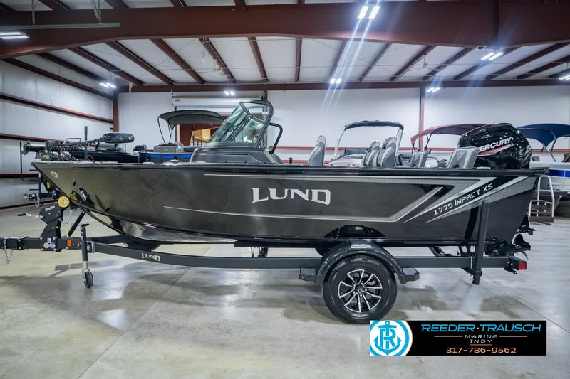 Slide: The Image of 2026 Lund 1775 Impact XS boat in showroom, side view, on trailer. - 10